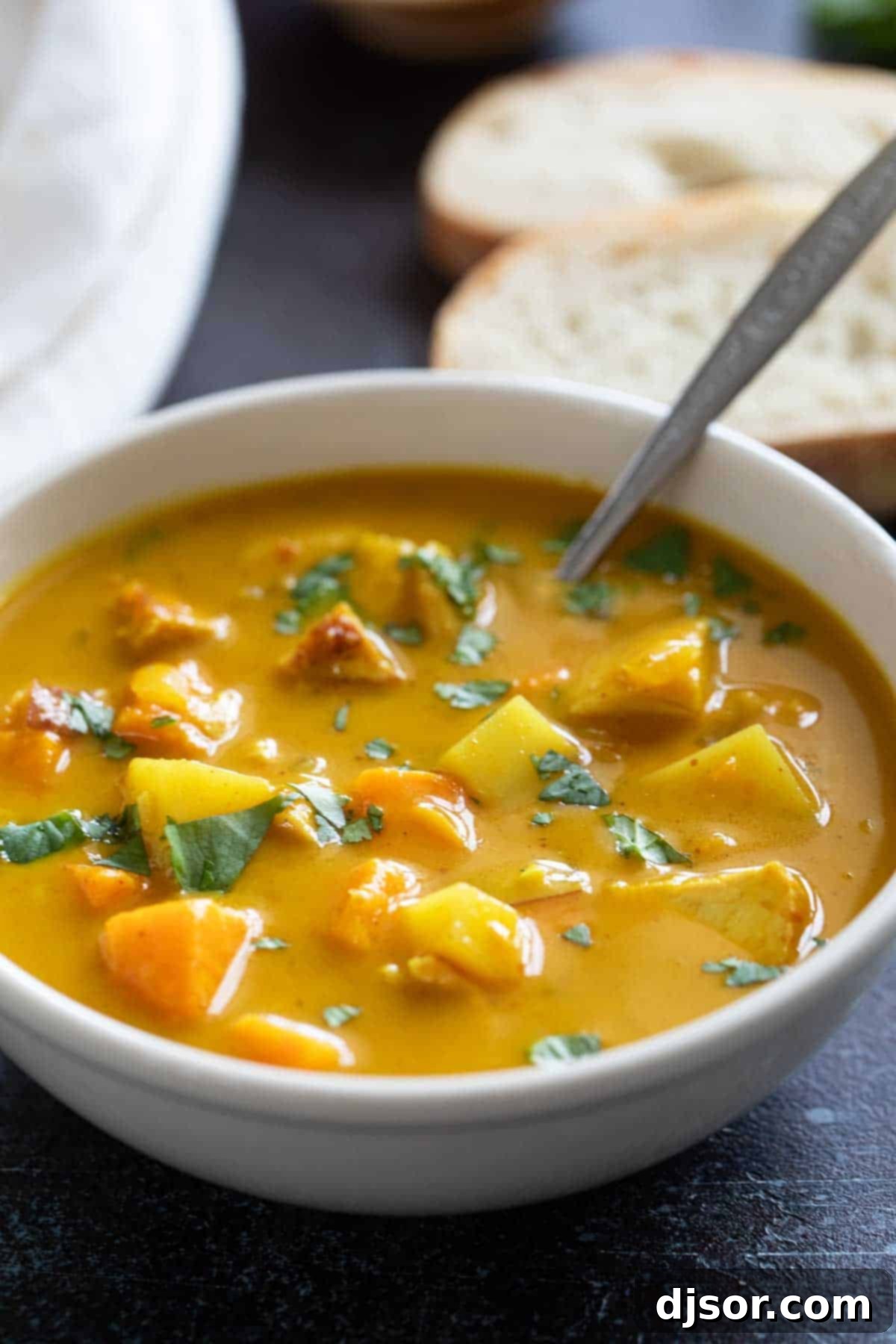 Delicious bowl of Chicken Curry Soup topped with fresh cilantro.