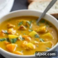Bowl of Chicken Curry Soup topped with cilantro.
