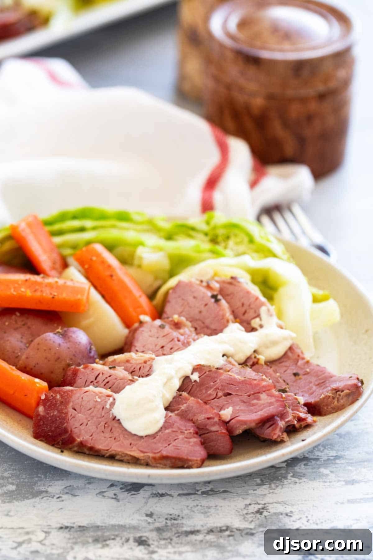 Corned Beef and Cabbage plated with potatoes and carrots.