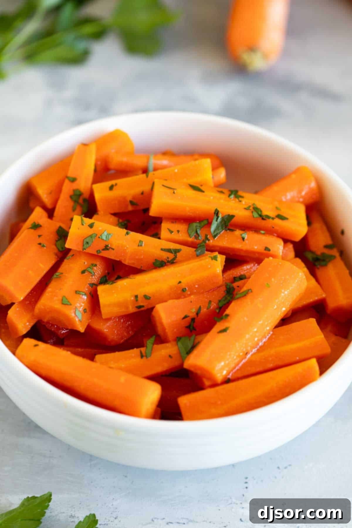Serving Slow Cooker Carrots A bowl of slow cooker carrots garnished with parsley.