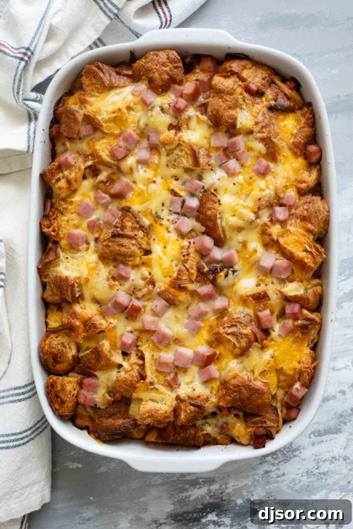The fully cooked Croissant Breakfast Casserole with melted ham and cheese, ready to be enjoyed.